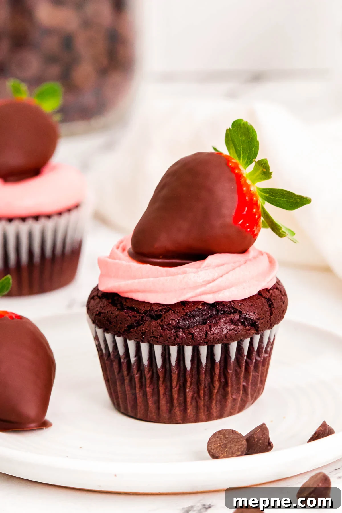 Close up photo of chocolate covered strawberry cupcakes on a white plate.