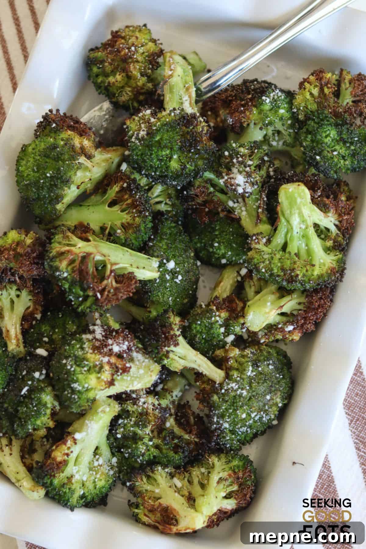 Crispy Air Fryer Broccoli Recipe 2 Air fried broccoli being served in a white dish.