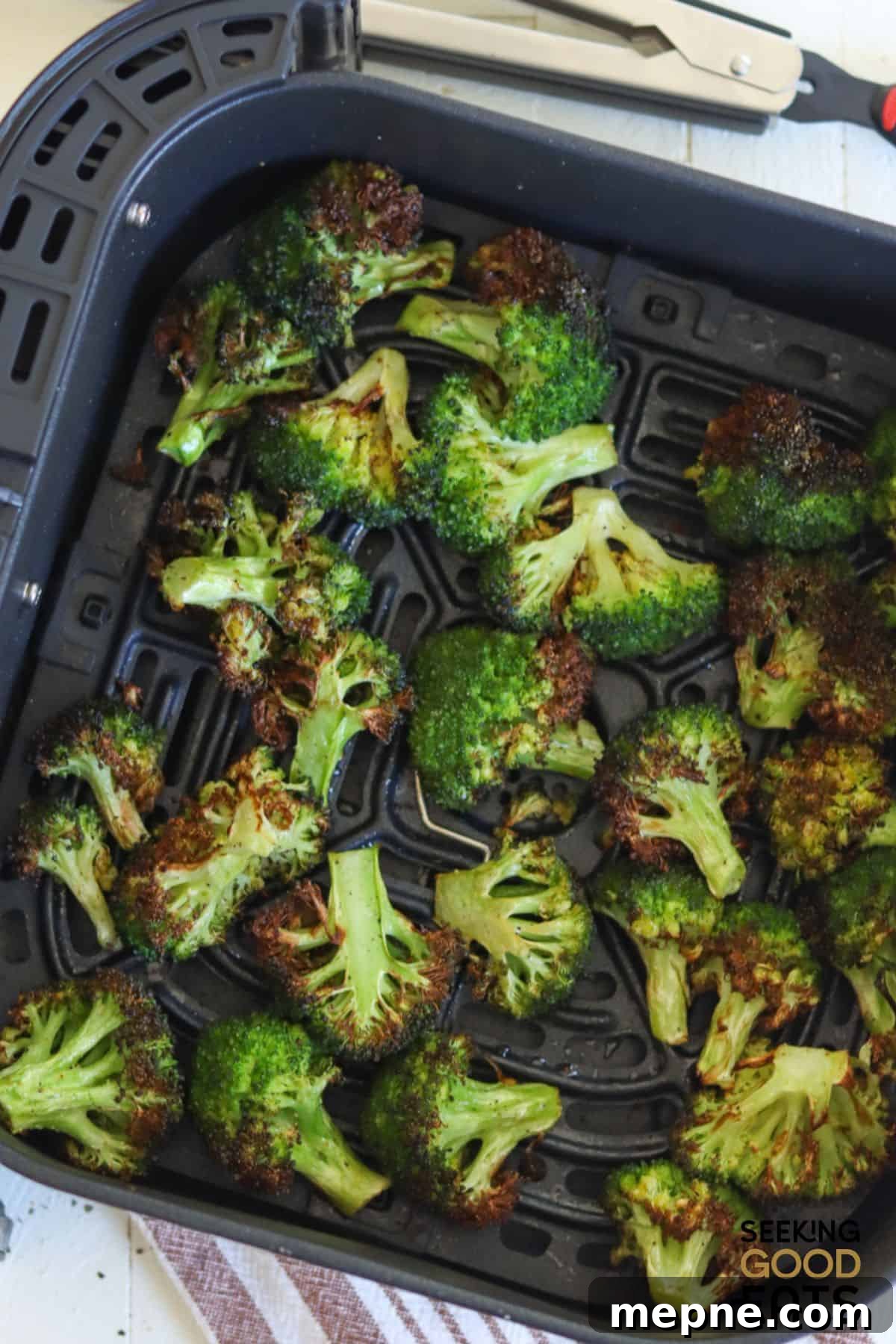 Crispy Air Fryer Broccoli Recipe 3 Cooked broccoli in the air fryer basket.