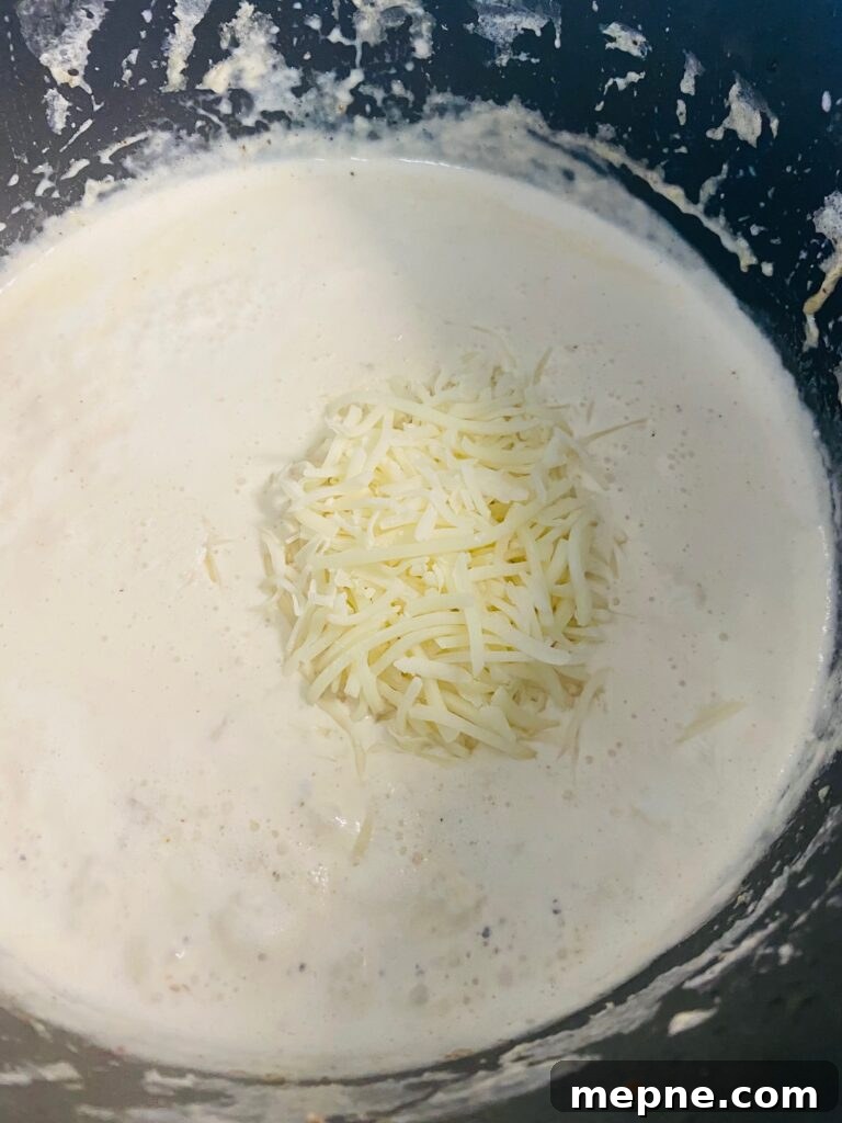 One-Pan Philly Cheesesteak Pasta Recipe 6 Making the homemade Alfredo sauce for the pasta