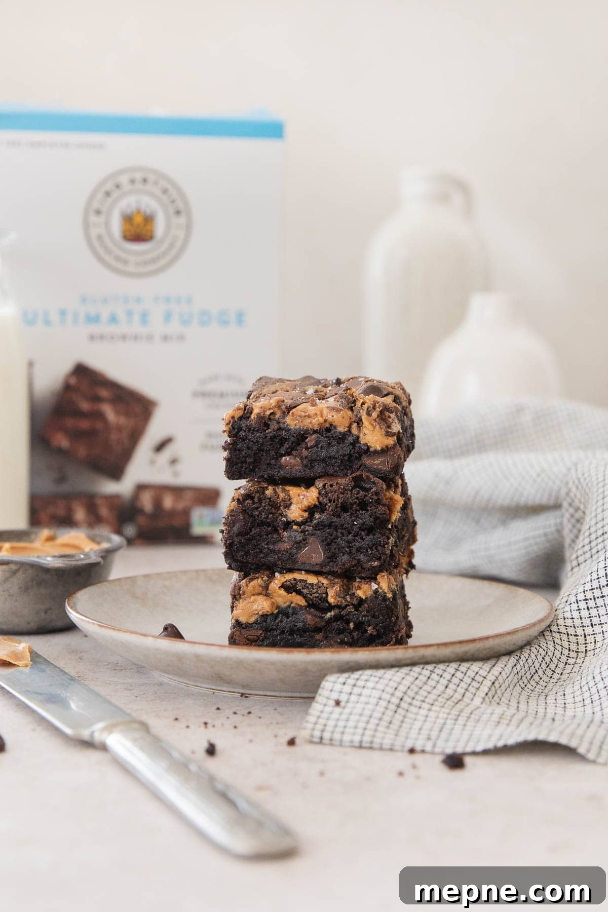 Gluten-Free Peanut Butter Brownies from Box Mix 3 Gluten-free peanut butter brownies sliced and stacked on a plate.