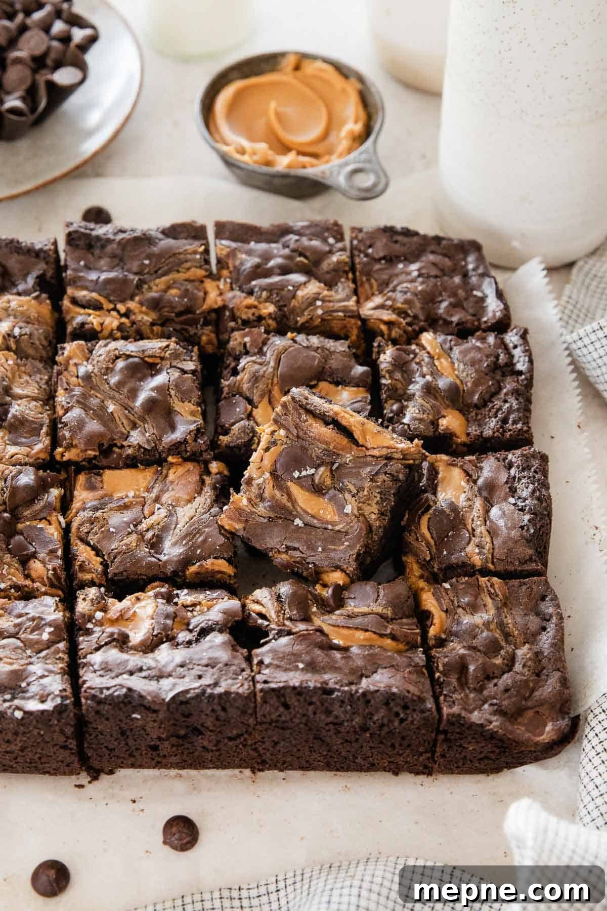 Gluten-Free Peanut Butter Brownies from Box Mix 7 Gluten-free peanut butter brownies sliced and laying on parchment.