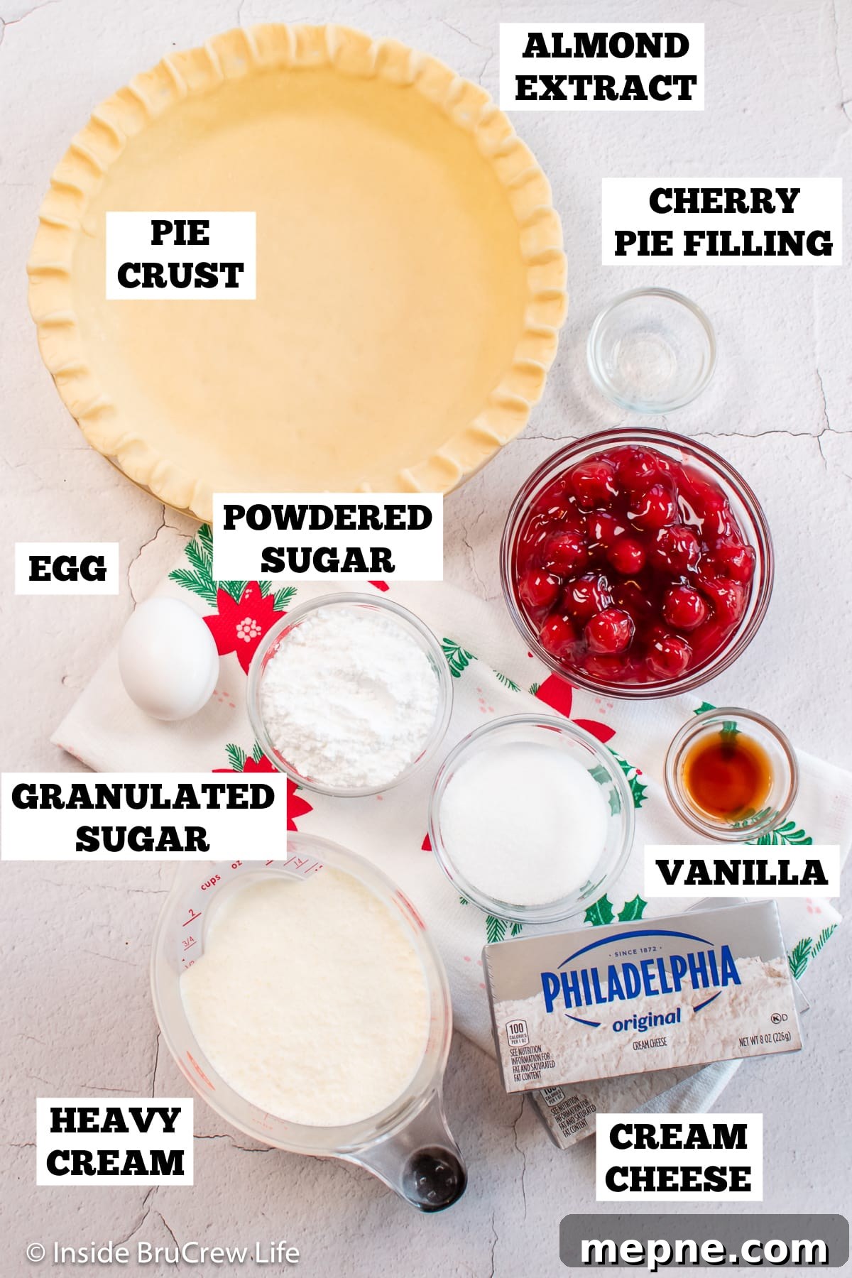 Cherry Pie with Cream Cheese Filling 3 A white board with bowls of ingredients needed to make a pie with cheesecake.