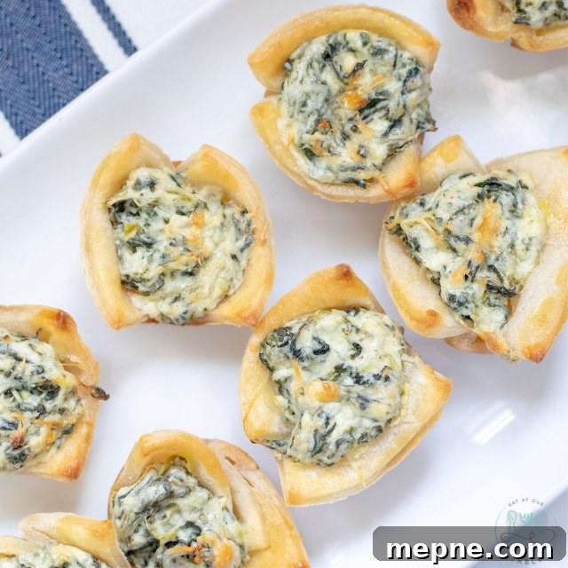 Mini Gluten-Free Spinach Dip Tarts in Puff Pastry 3 Mini spinach tarts on a plate