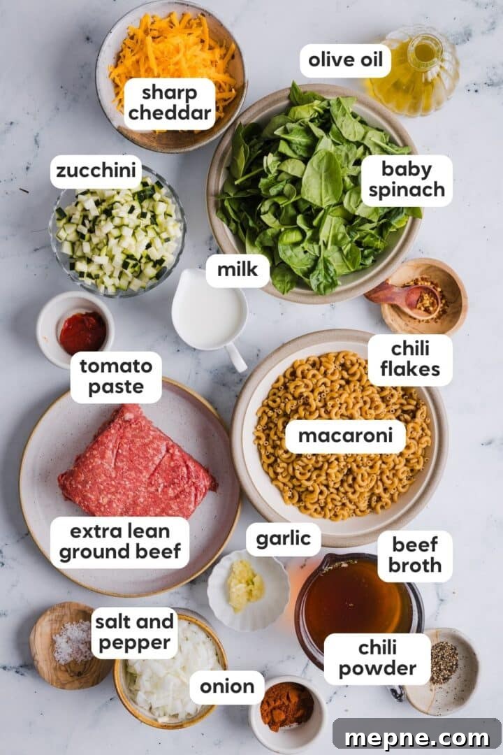 Lighter Homemade Hamburger Helper Recipe 3 ingredients for homemade hamburger helper displayed in small bowls on a kitchen counter