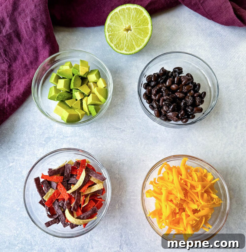 Shrimp Taco Salad with Creamy Lime Dressing 3 fresh lime, avocados, black beans, tortilla chips, and shredded cheese in separate glass bowls