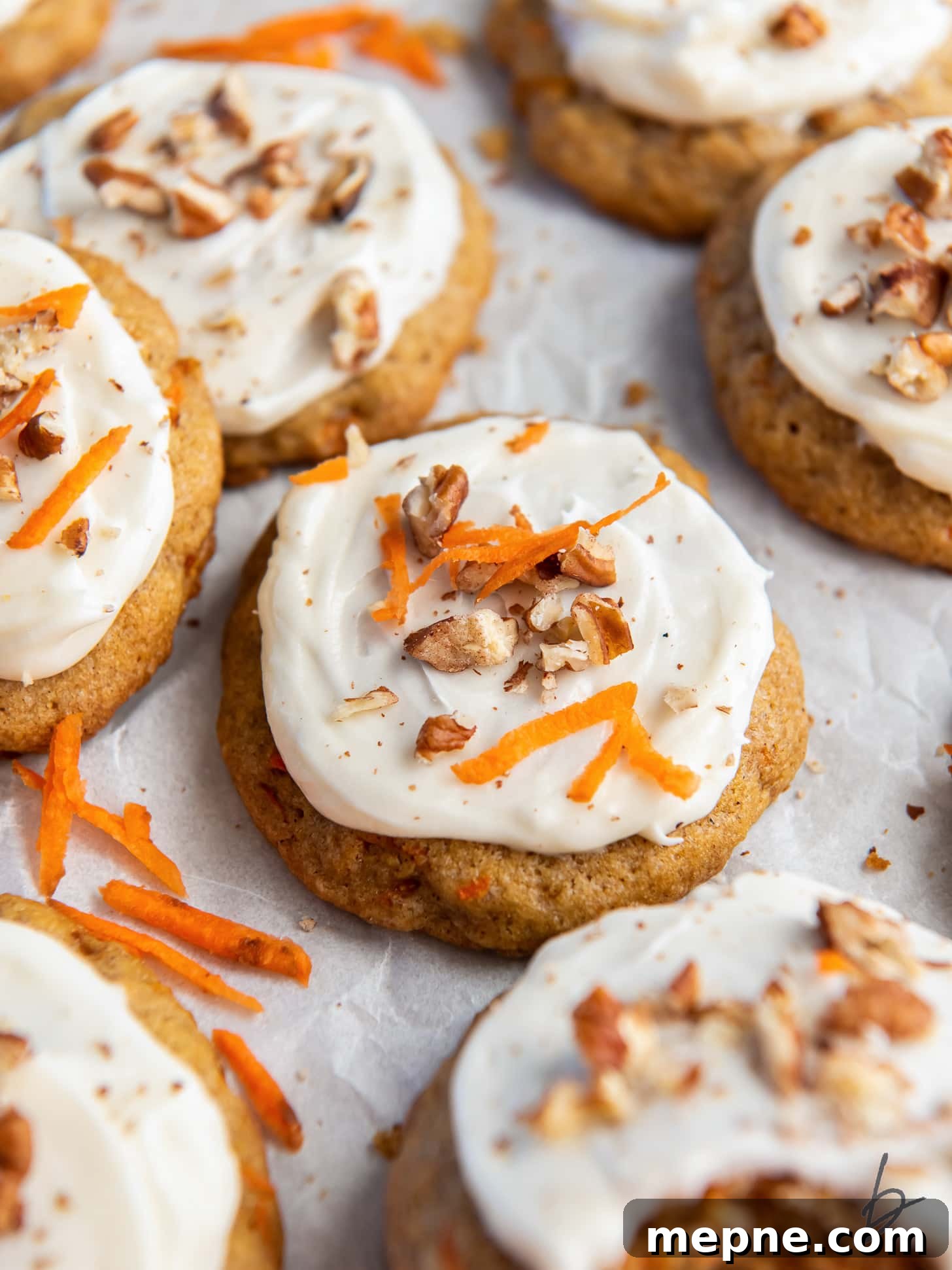 Spiced Carrot Cake Cookies with Cream Cheese Frosting 7 carrot cake cookie with cream cheese frosting and walnut garnish.