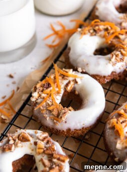 frosted carrot cake donuts garnish with chopped nuts and shredded carrot