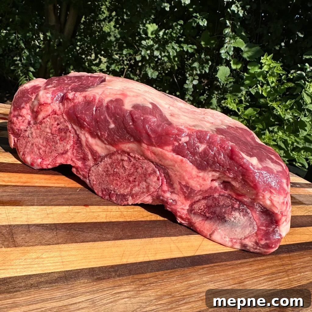 raw rack of beef ribs on a cutting board.
