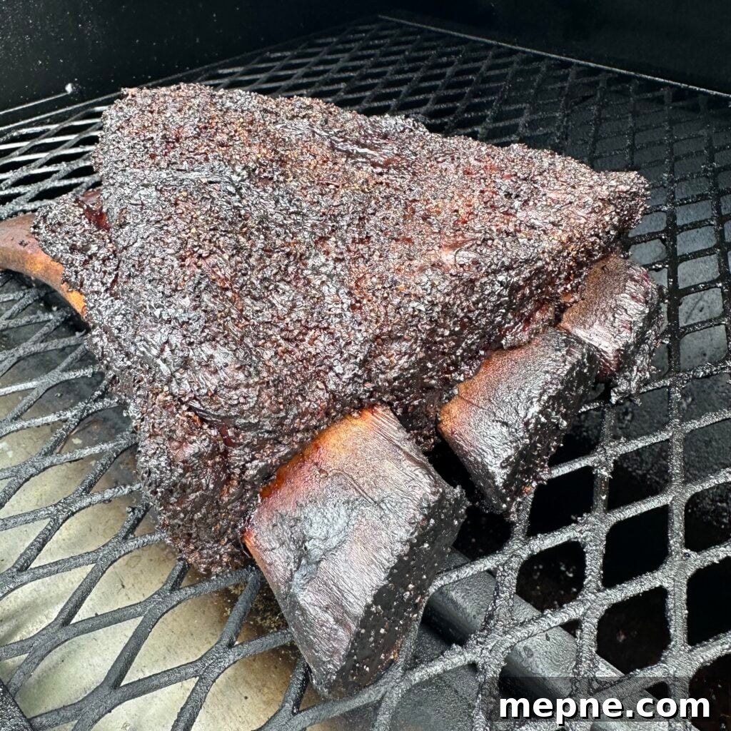 Beef ribs smoking on a smoker.