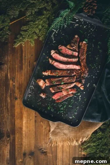 How to Grill London Broil for Tender Juicy Results 11 Sliced grilled ribeye on a serving platter.