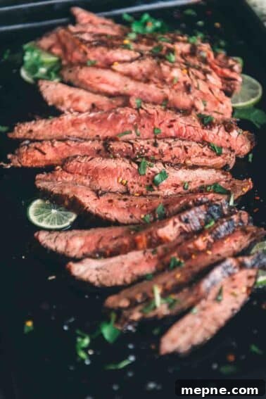 How to Grill London Broil for Tender Juicy Results 12 Close up of slices of grilled flank steak, showing a pink medium rare center.