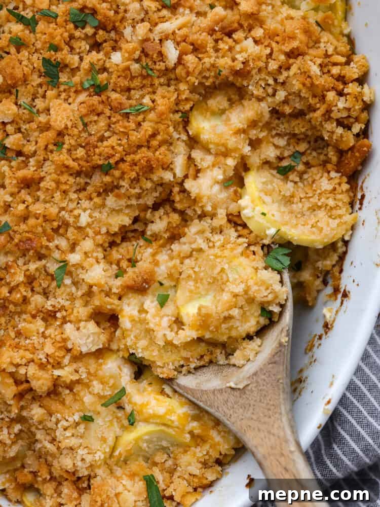 Close-up of squash casserole. A close up of squash casserole with a wooden spoon.