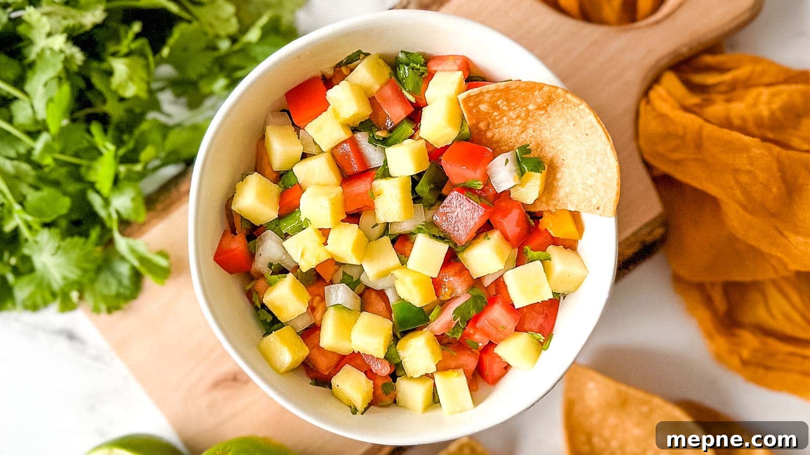 Pineapple Pico de Gallo Recipe: Tropical Salsa 13 Overhead shot of pineapple pico de gallo in a white bowl.