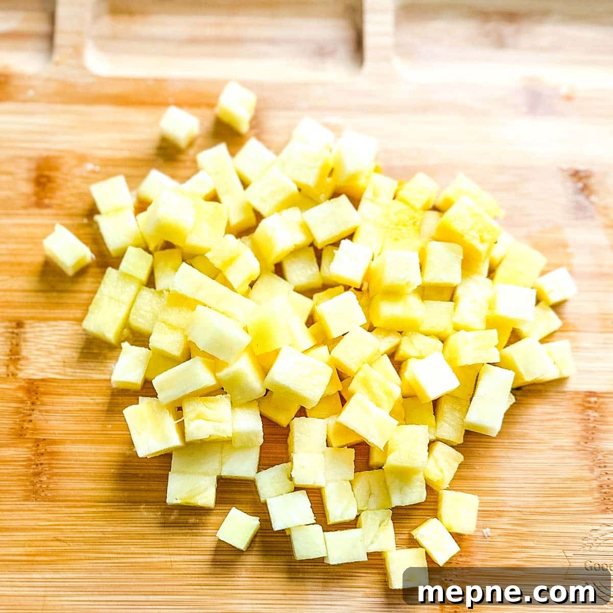 Pineapple Pico de Gallo Recipe: Tropical Salsa 4 Diced pineapple on a wooden cutting board.