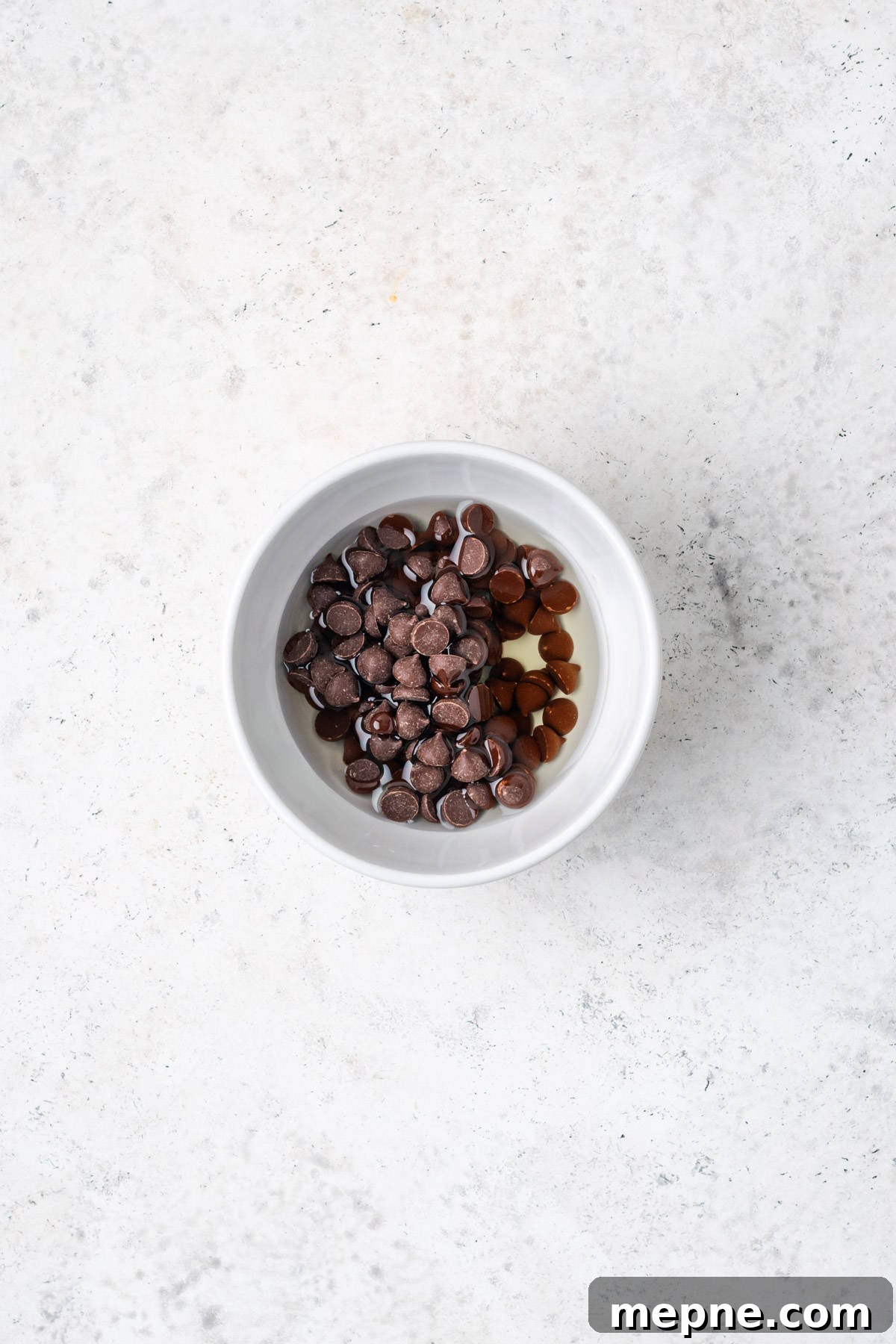 Fudgy Small-Batch Brownies Recipe 3 Chocolate chips and oil combined in a small bowl.