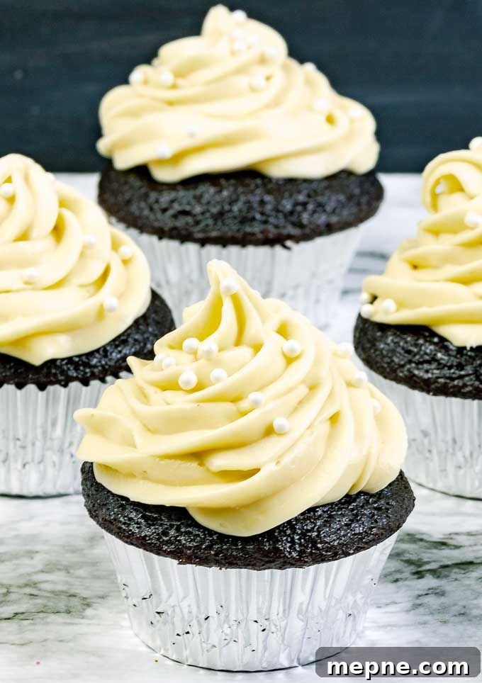 Guinness Dark Chocolate Cupcakes with Irish Cream Cheese Frosting 2 four Guinness Dark Chocolate Cupcakes with Irish Cream Cream Cheese Frosting in silver wrappers