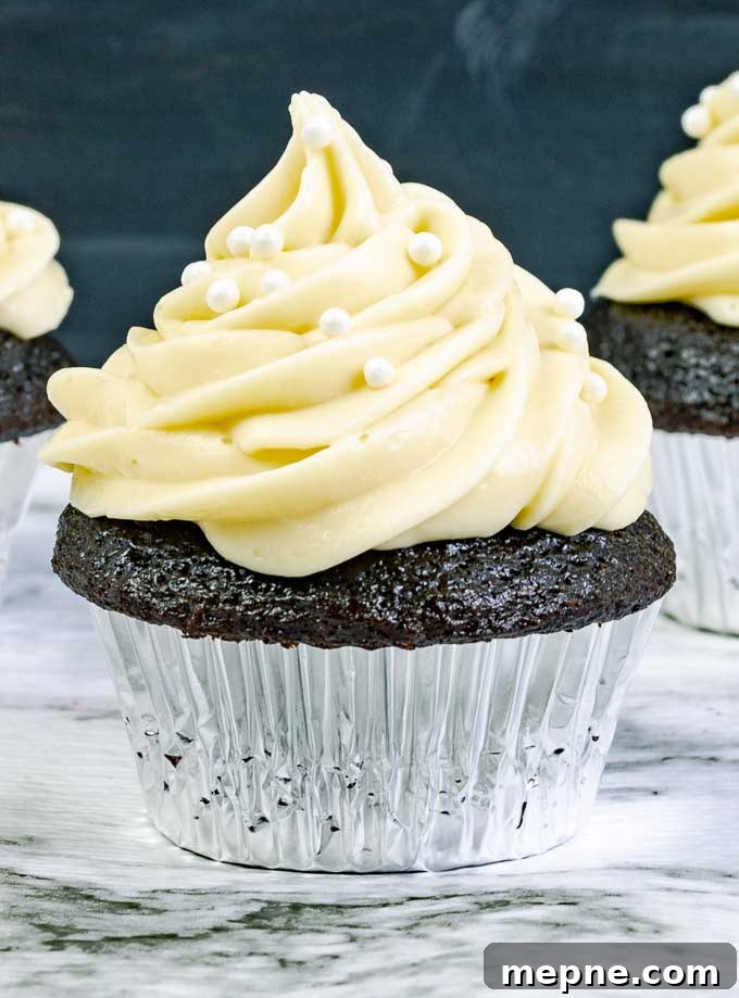 Guinness Dark Chocolate Cupcakes with Irish Cream Cheese Frosting 5 close up of a Guinness Dark Chocolate Cupcake with Irish Cream Cream Cheese Frosting in a silver wrapper