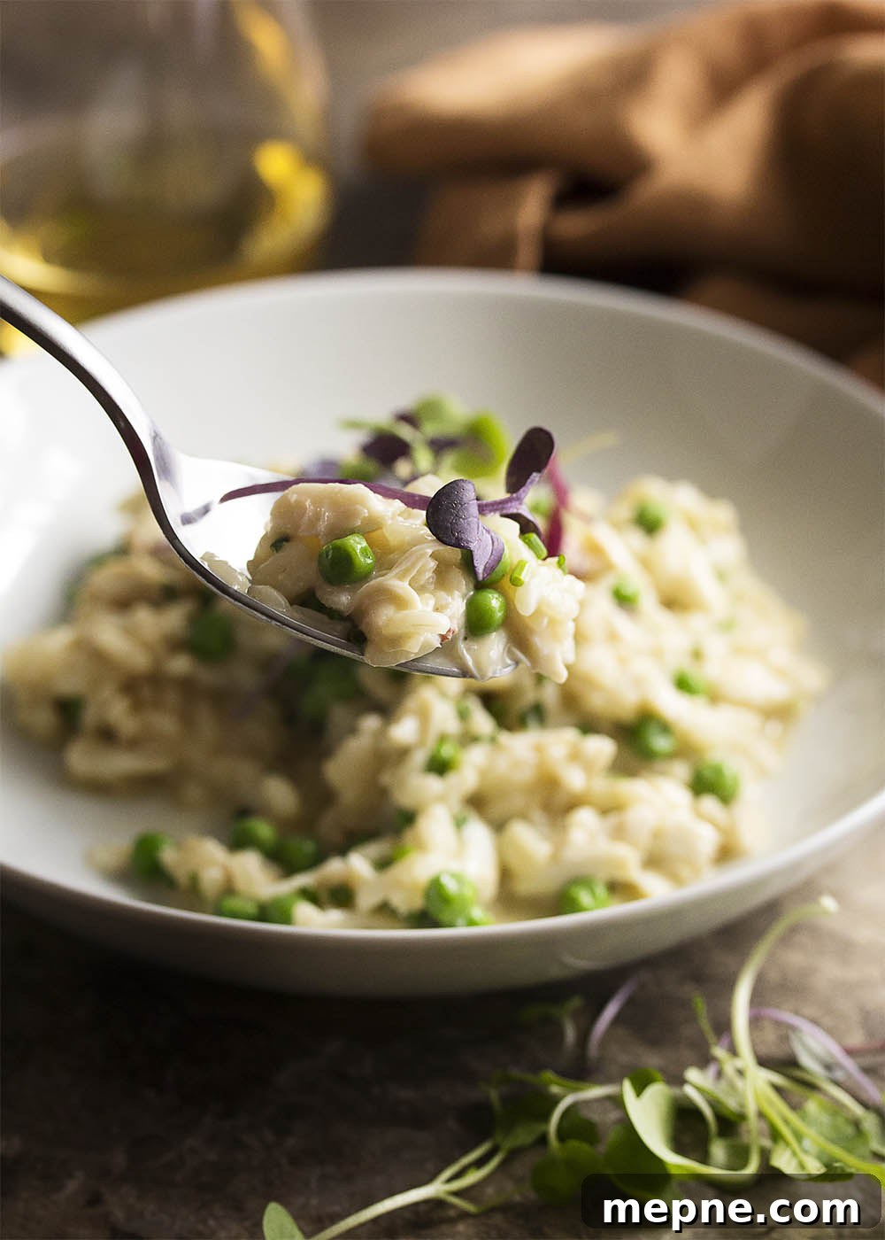 Creamy Crab Risotto with Mascarpone and Peas 4 A bowl of crab risotto with mascarpone, peas, chives, and microgreens.