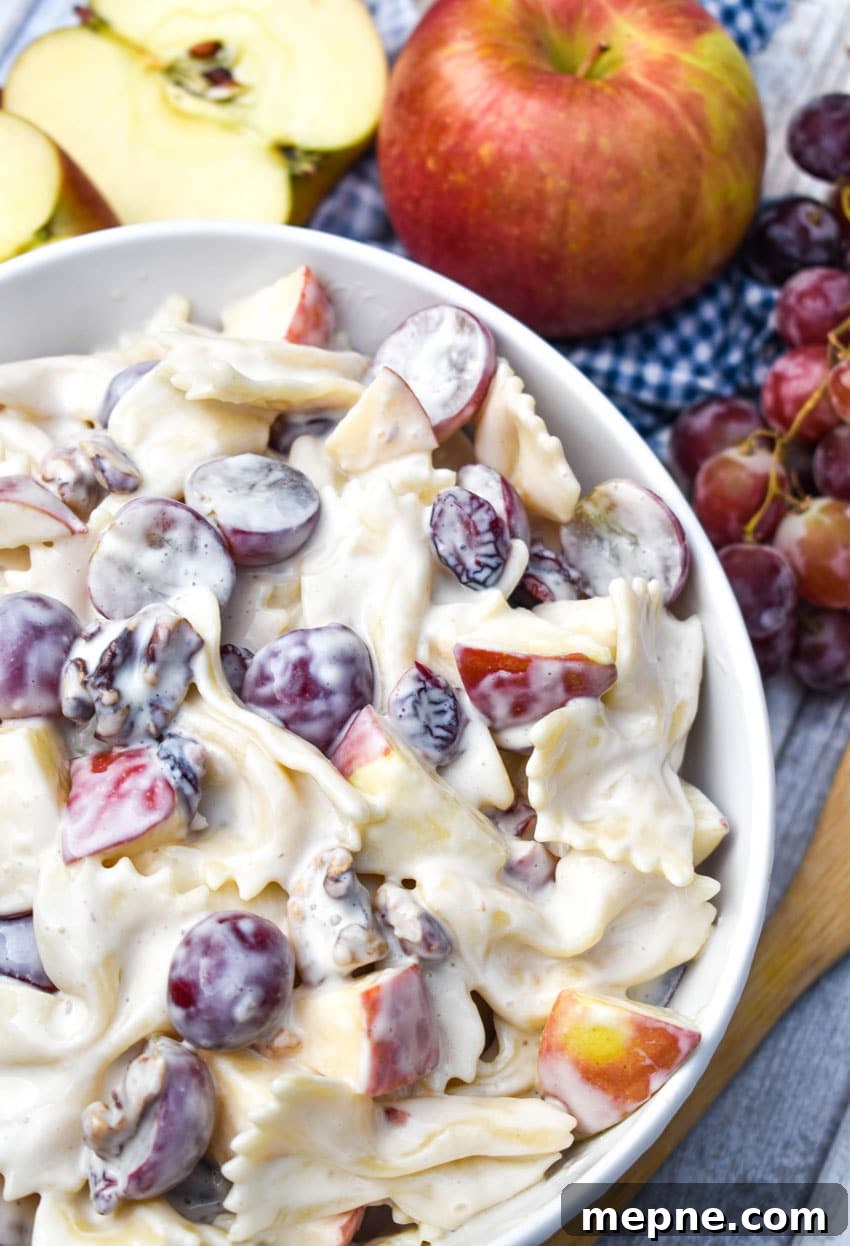 Summer Fruit and Honey Pasta Salad Recipe 2 sweet pasta salad with fruit and honey in a white bowl surrounded by fresh fruits