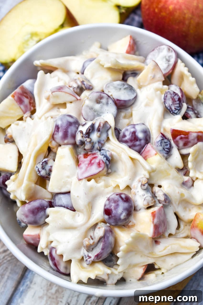 Summer Fruit and Honey Pasta Salad Recipe 3 sweet pasta salad with fruit and honey in a white bowl surrounded by fresh fruits