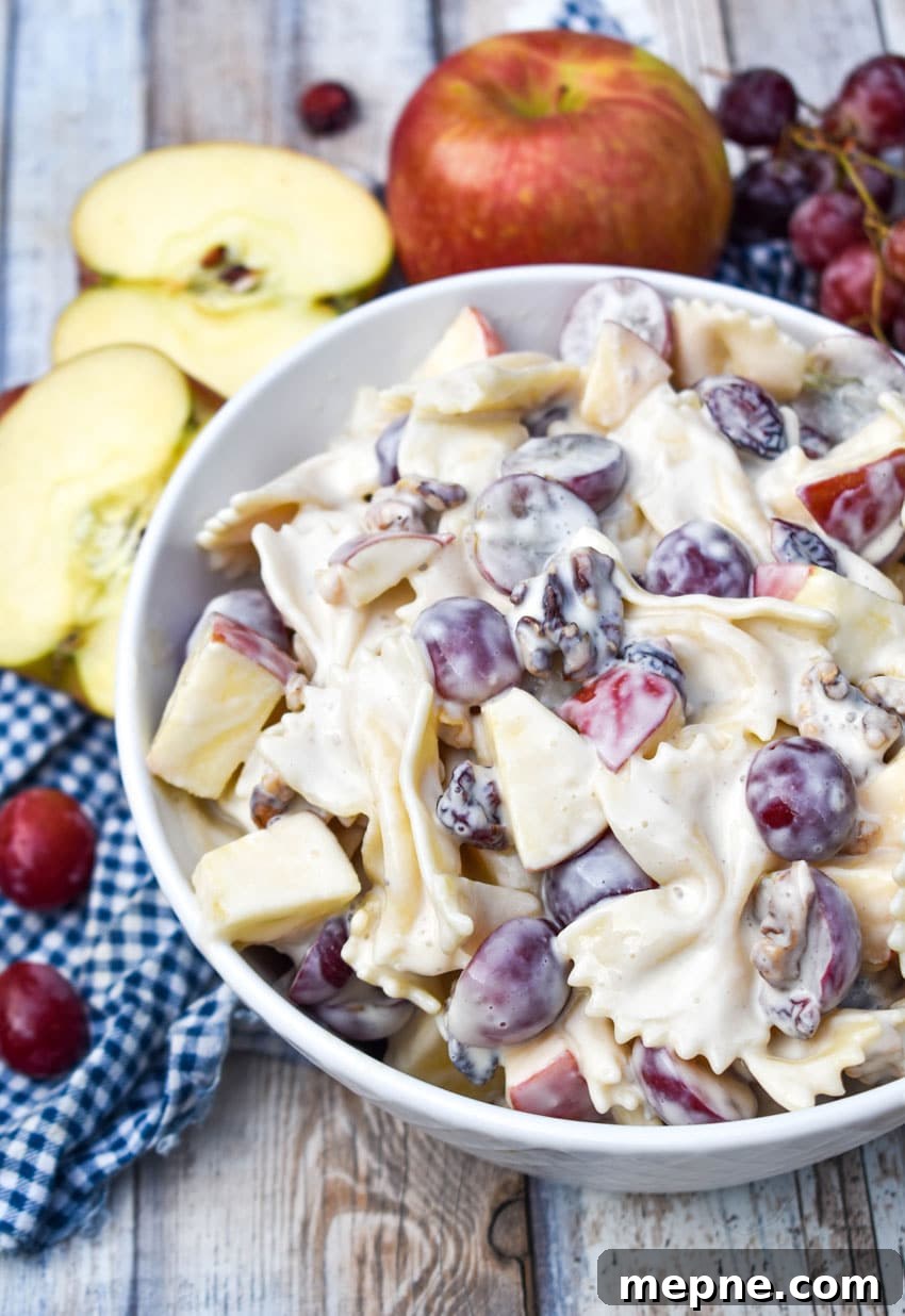 Summer Fruit and Honey Pasta Salad Recipe 4 sweet pasta salad with fruit and honey in a white bowl surrounded by fresh fruits