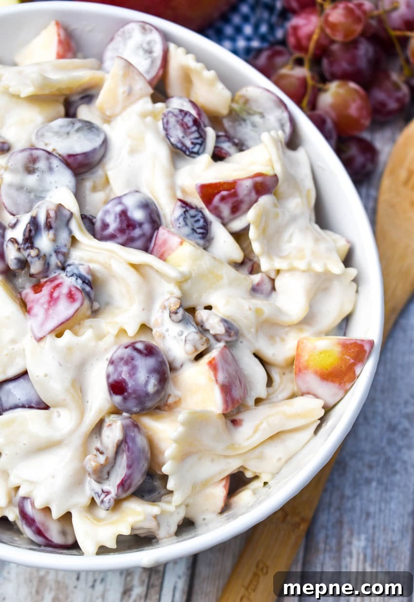Summer Fruit and Honey Pasta Salad Recipe 5 sweet pasta salad with fruit and honey in a white bowl surrounded by fresh fruits