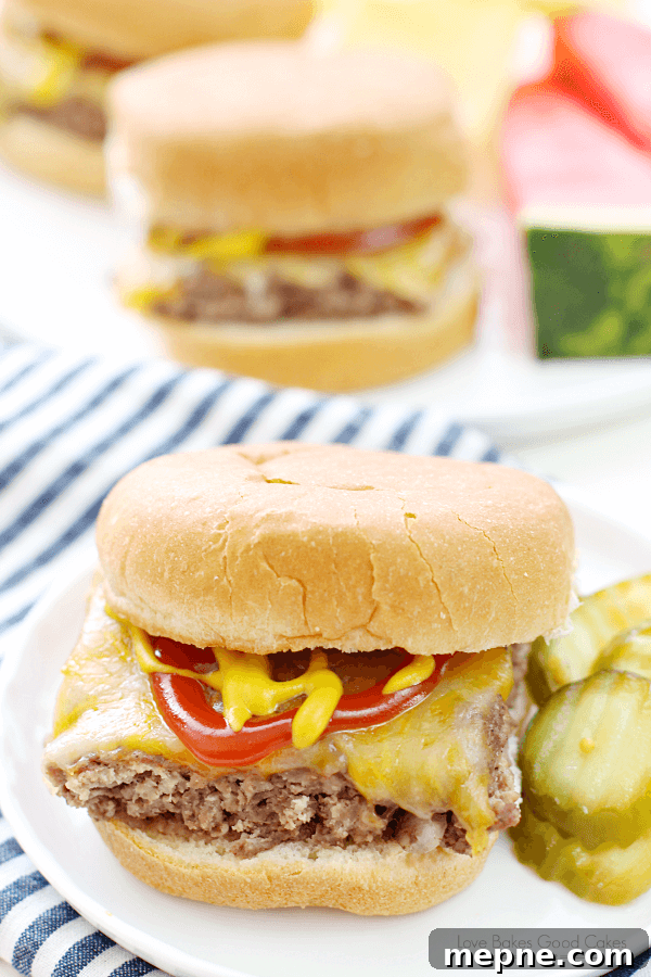 Quick Homemade Beef Sliders Recipe 2 Easy Beef Slider on a white plate with sliced pickles.