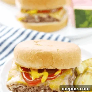 Quick Homemade Beef Sliders Recipe 3 Easy Beef Slider on a white plate with sliced pickles.