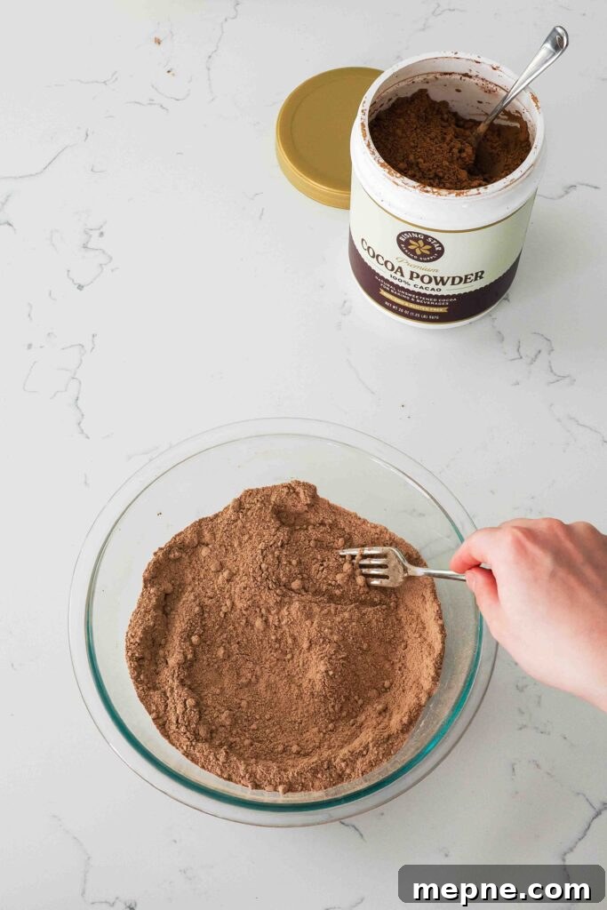 Moist and Fudgy Double Chocolate Muffins Recipe 5 A fork breaks up any large clumps in the dry ingredients for chocolate muffins.