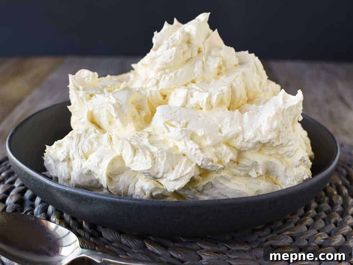 How to Make Italian Meringue Buttercream 5 Thick creamy frosting piled high in a bowl.