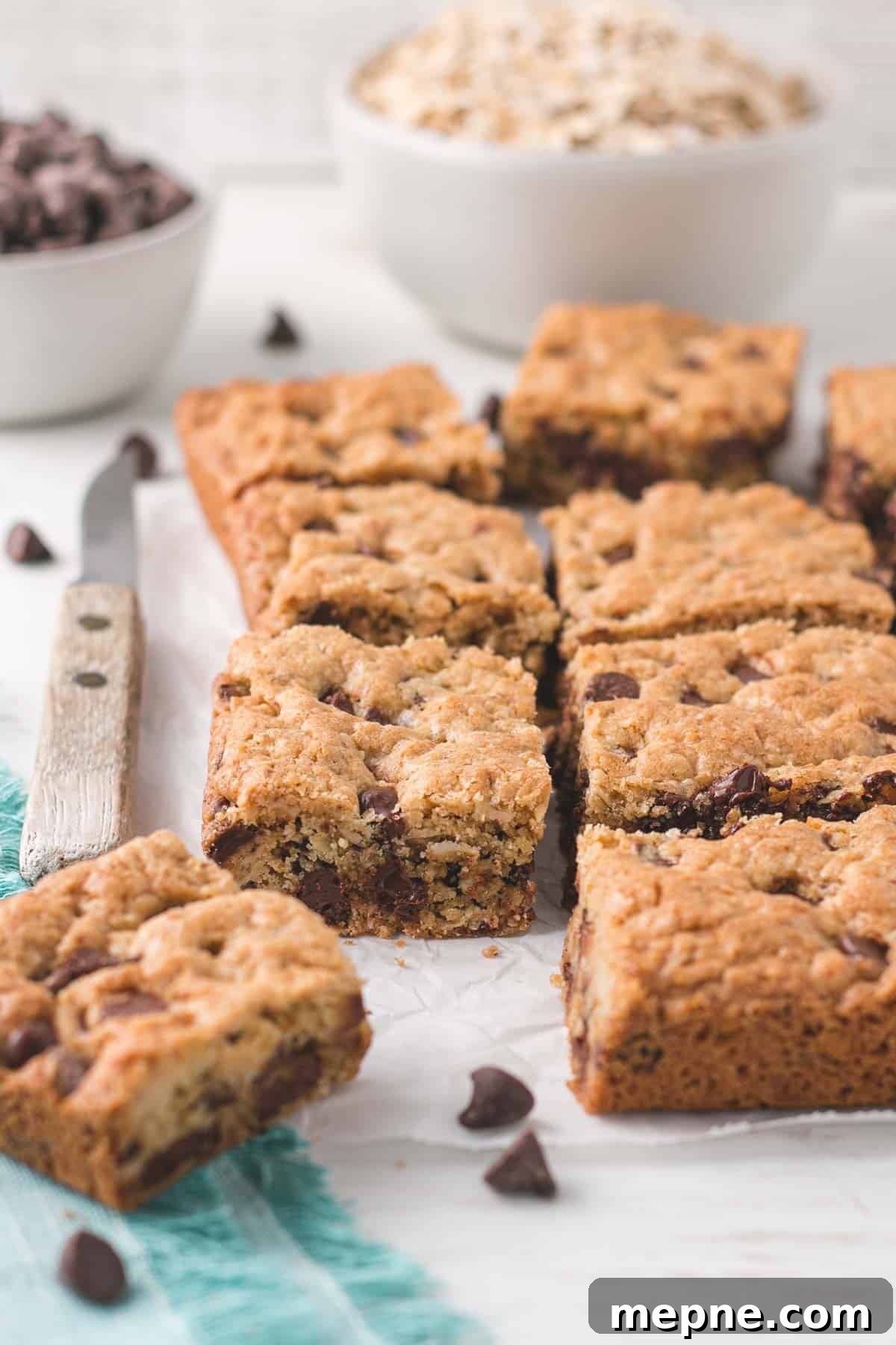 Chewy Gluten-Free Oatmeal Chocolate Chip Cookie Bars 6 Bars sliced into squares showing the chocolate chips on the inside.