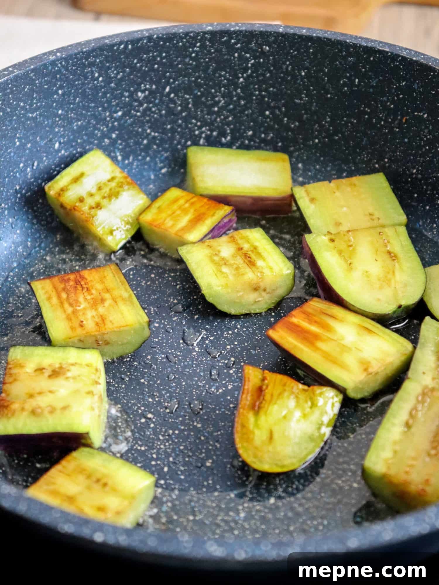 Binagoongang Talong: Eggplant in Shrimp Paste 4 frying eggplants in a pan