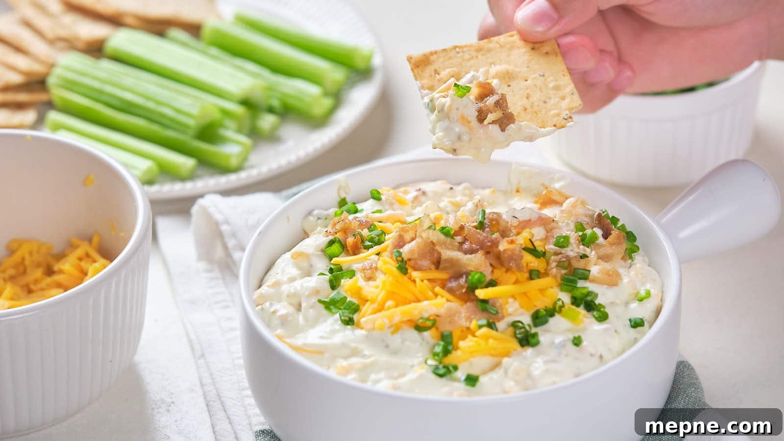 13 Low-Carb Holiday Appetizers to Impress Guests 5 Bacon cheddar dip with shredded cheddar cheese, bacon bits, and chive garnish.
