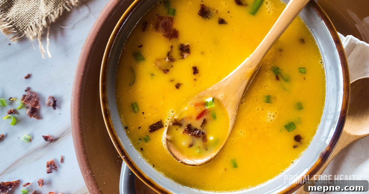 13 Low-Carb Holiday Appetizers to Impress Guests 8 Beer cheese soup with wooden spoon in a bowl.