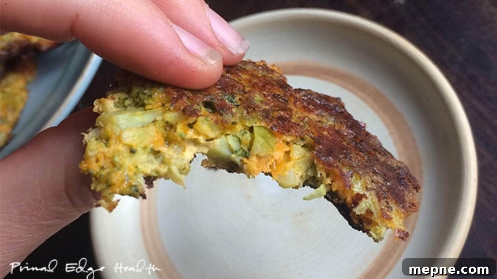 13 Low-Carb Holiday Appetizers to Impress Guests 10 A close-up of a hand holding a partially eaten broccoli fritter over a round plate.