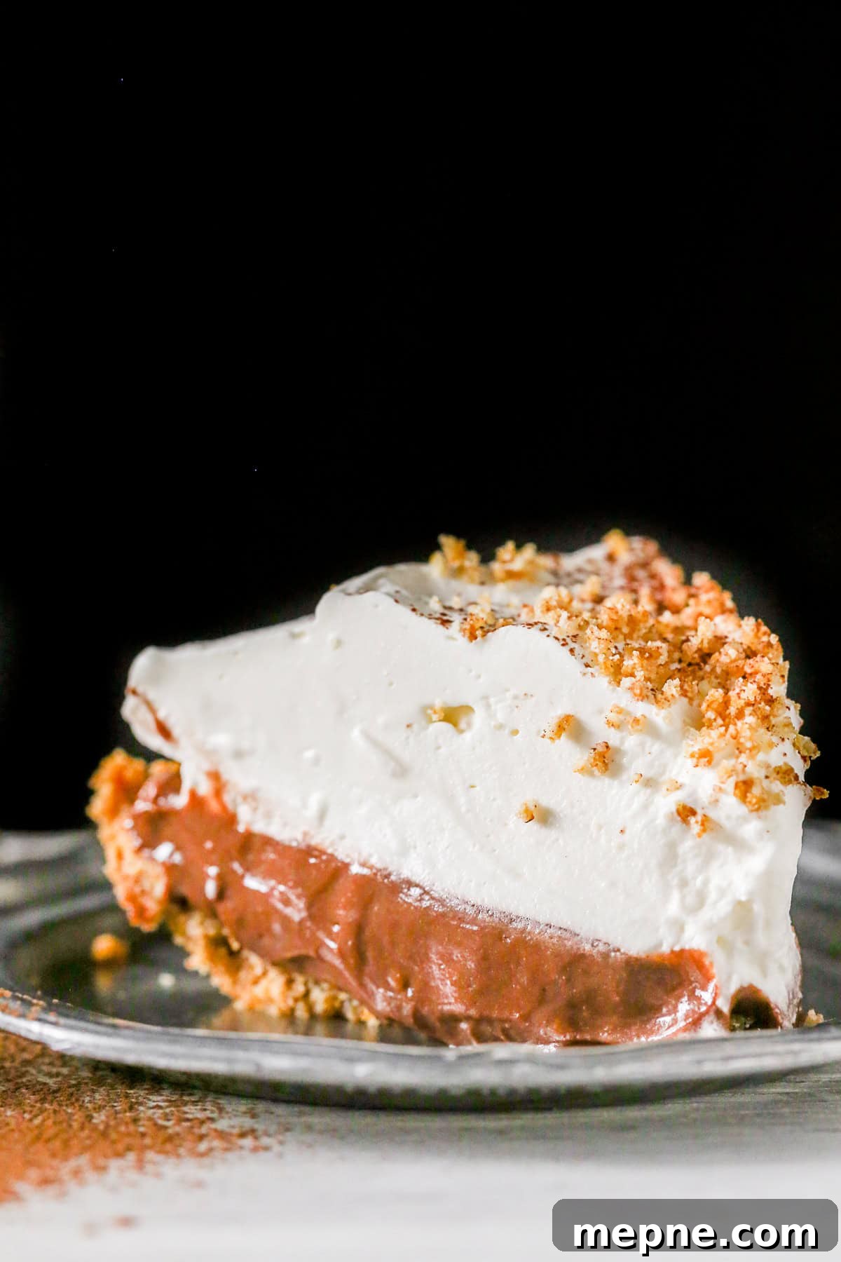 Chocolate Orange Pudding Pie Recipe 2 Chocolate Orange Pudding Pie sliced on a small plate.