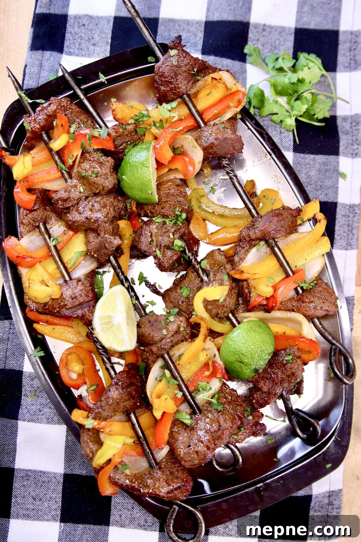 platter of grilled steak and peppers.