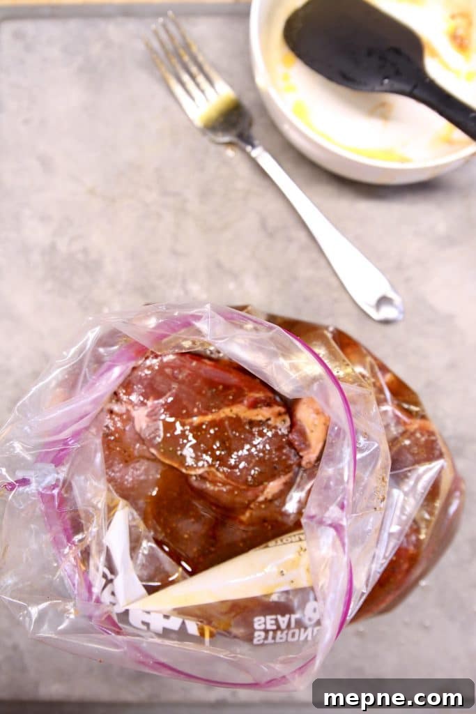 steak in a zip top bag with marinade poured over.