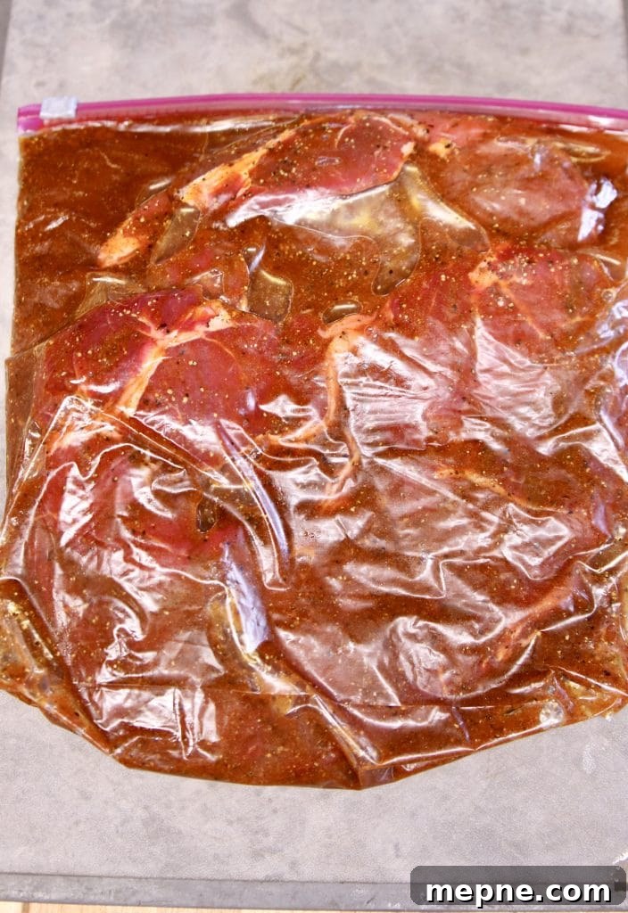 Marinating steak in a zip top bag with fajita marinade.