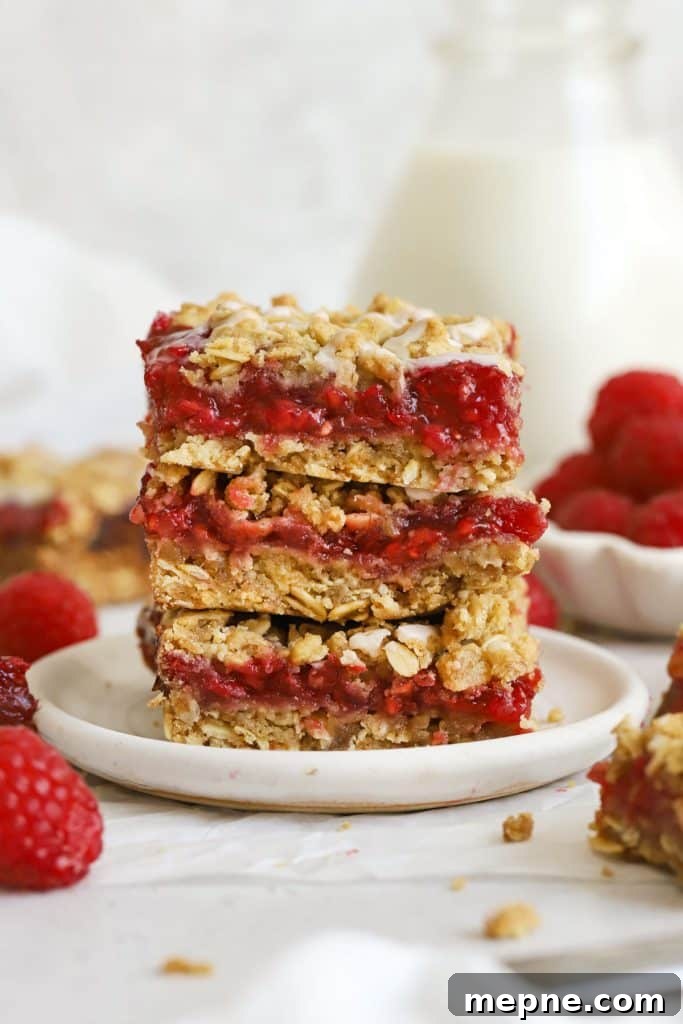 Gluten-Free Key Lime Pie Bars Recipe: Zesty Lime Squares 11 three gluten-free raspberry crumble bars stacked on a white plate