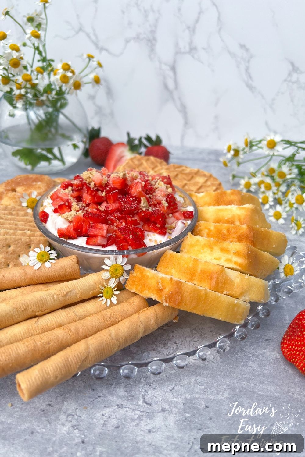 No-Bake Strawberry Cheesecake Dip: A Velvety, Decadent Treat 2 A no bake strawberry cheesecake dip topped with diced strawberries and crushed graham crackers