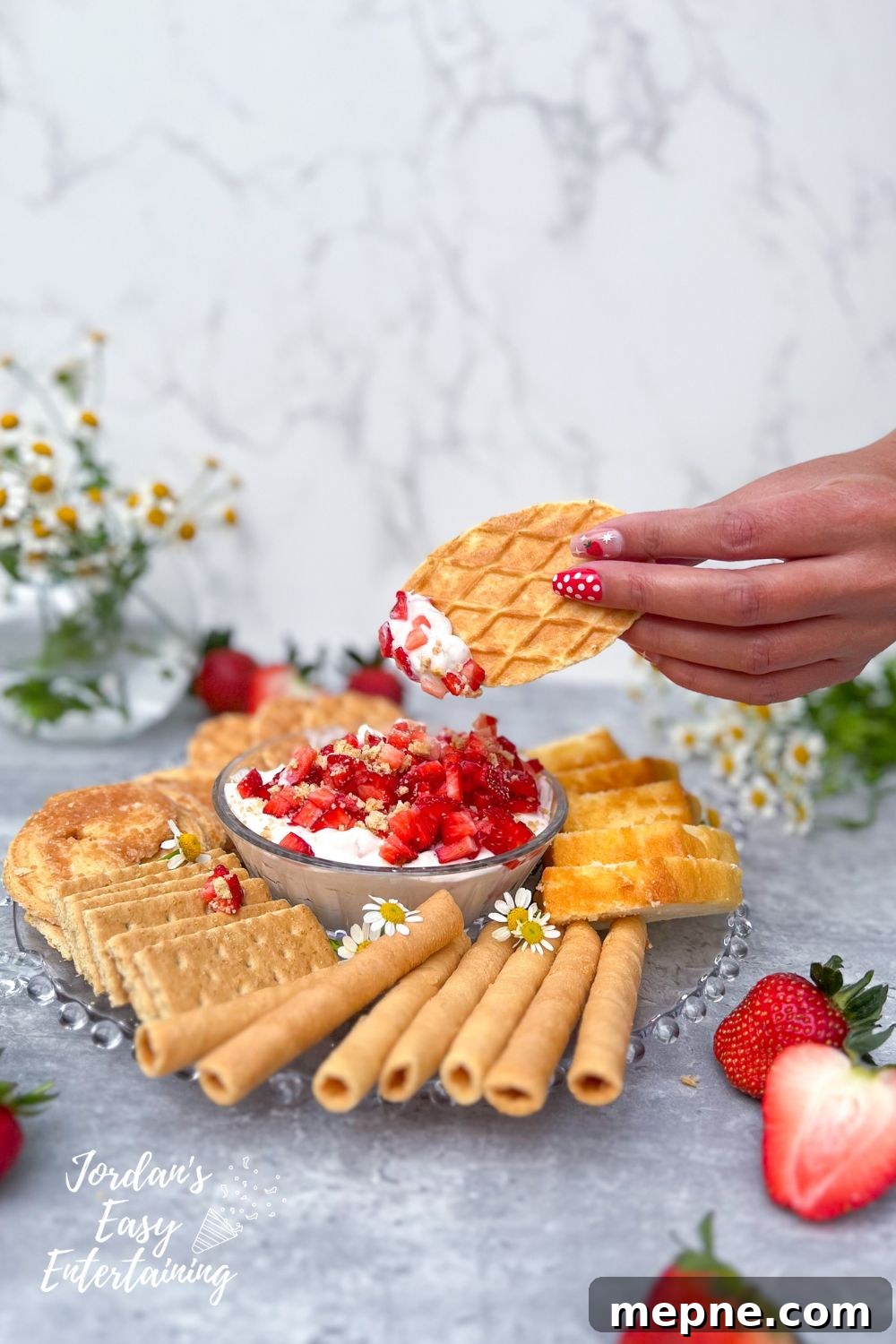 No-Bake Strawberry Cheesecake Dip: A Velvety, Decadent Treat 5 a waffle cookie with some no bake strawberry cheesecake dip with a confetti of diced strawberry