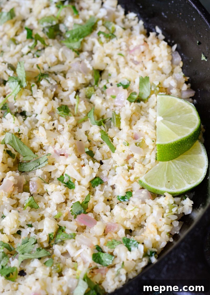 Keto Cilantro Lime Shrimp with Cauliflower Rice 4 A cast iron skillet filled with perfectly cooked cilantro lime cauliflower rice