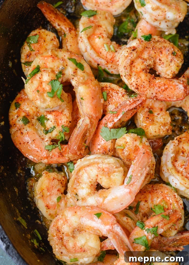 Keto Cilantro Lime Shrimp with Cauliflower Rice 5 Juicy cilantro lime shrimp in a buttery garlic sauce in a cast iron pan