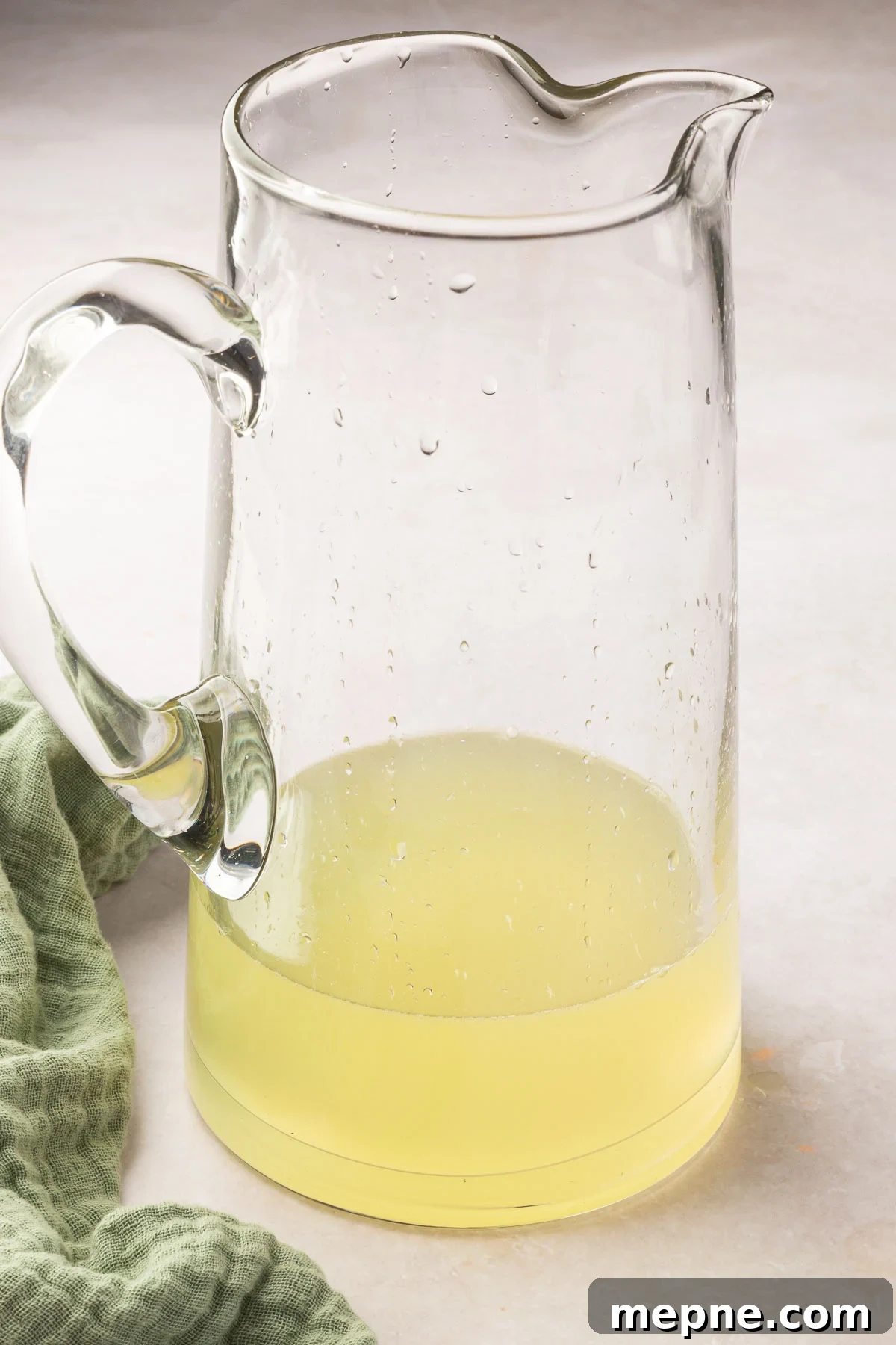 Fresh Basil Lemonade Recipe 7 A glass pitcher of lemonade concentrate before adding additional water.