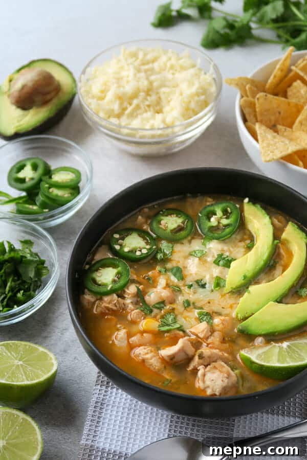 Instant Pot White Chicken Chili: Dairy Free Recipe 2 instant pot white chicken chili (dairy-free) shown with toppings: jalapeño, avocado, cilantro, Monterey jack cheese, and limes