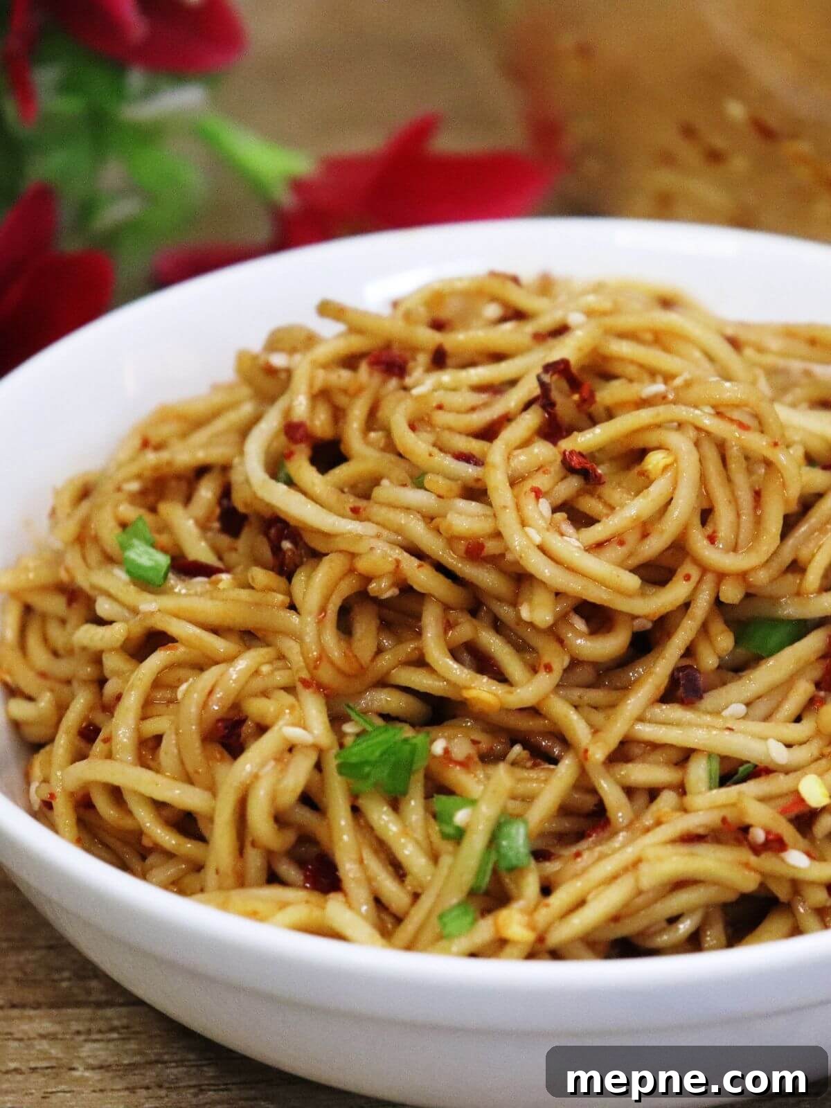 garlic chili oil noodles served in a whte bowl.