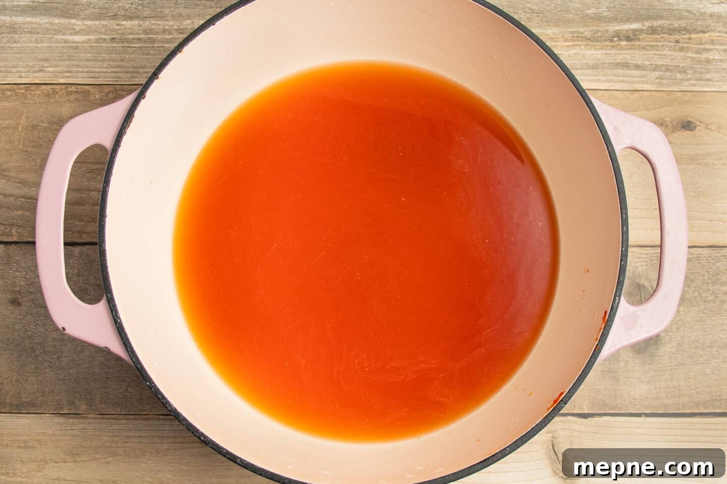 Creamy Roasted Garlic Tomato Soup Recipe 6 This is a picture of a pot with tomato paste and broth.