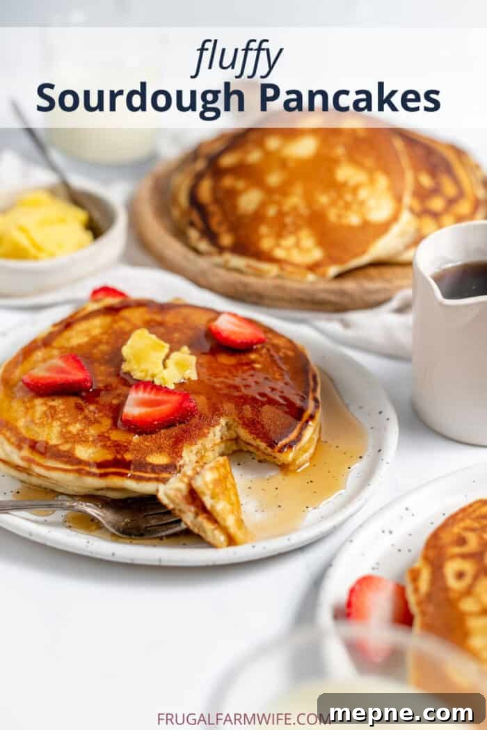 How to Make Fluffy Sourdough Pancakes from Your Starter 9 sourdough pancakes served on a plate with strawberries